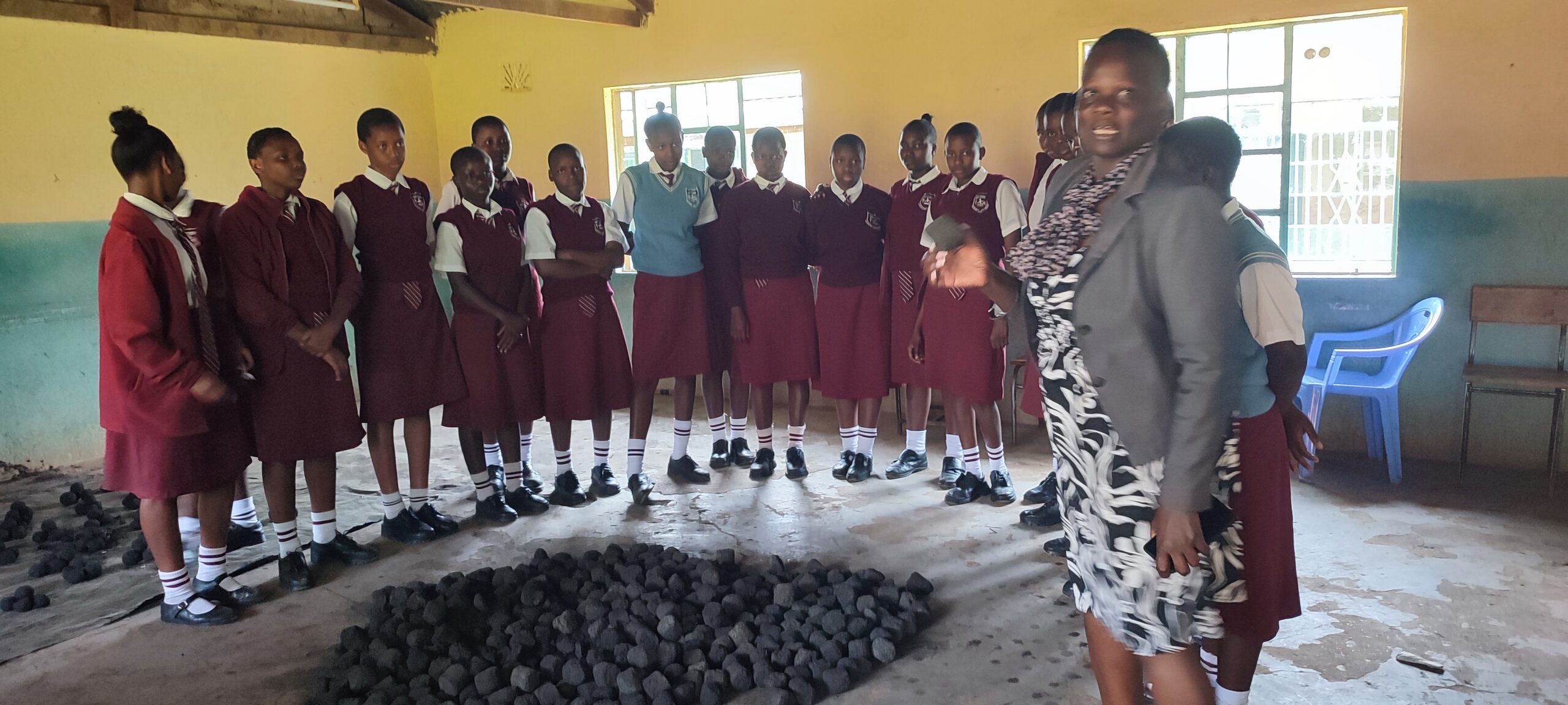 Ambassador Naomi Nancy Nakhumicha Wanyonyi (HSC,OGW) showcasing how to make briquette