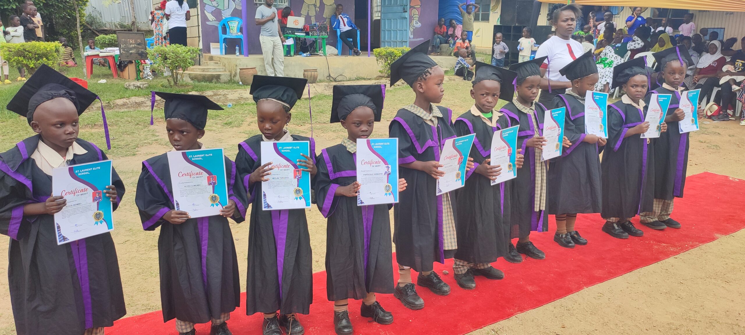 Graduands showcasing their certificates.