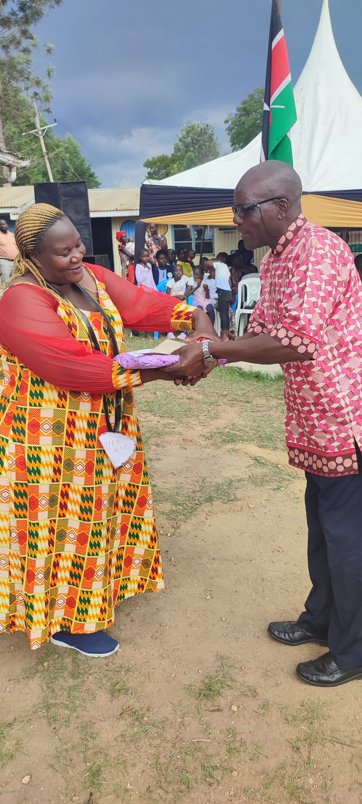 BOM chair, Mr Saferio Okoth awarding chief speaker, Sheila Ameyo